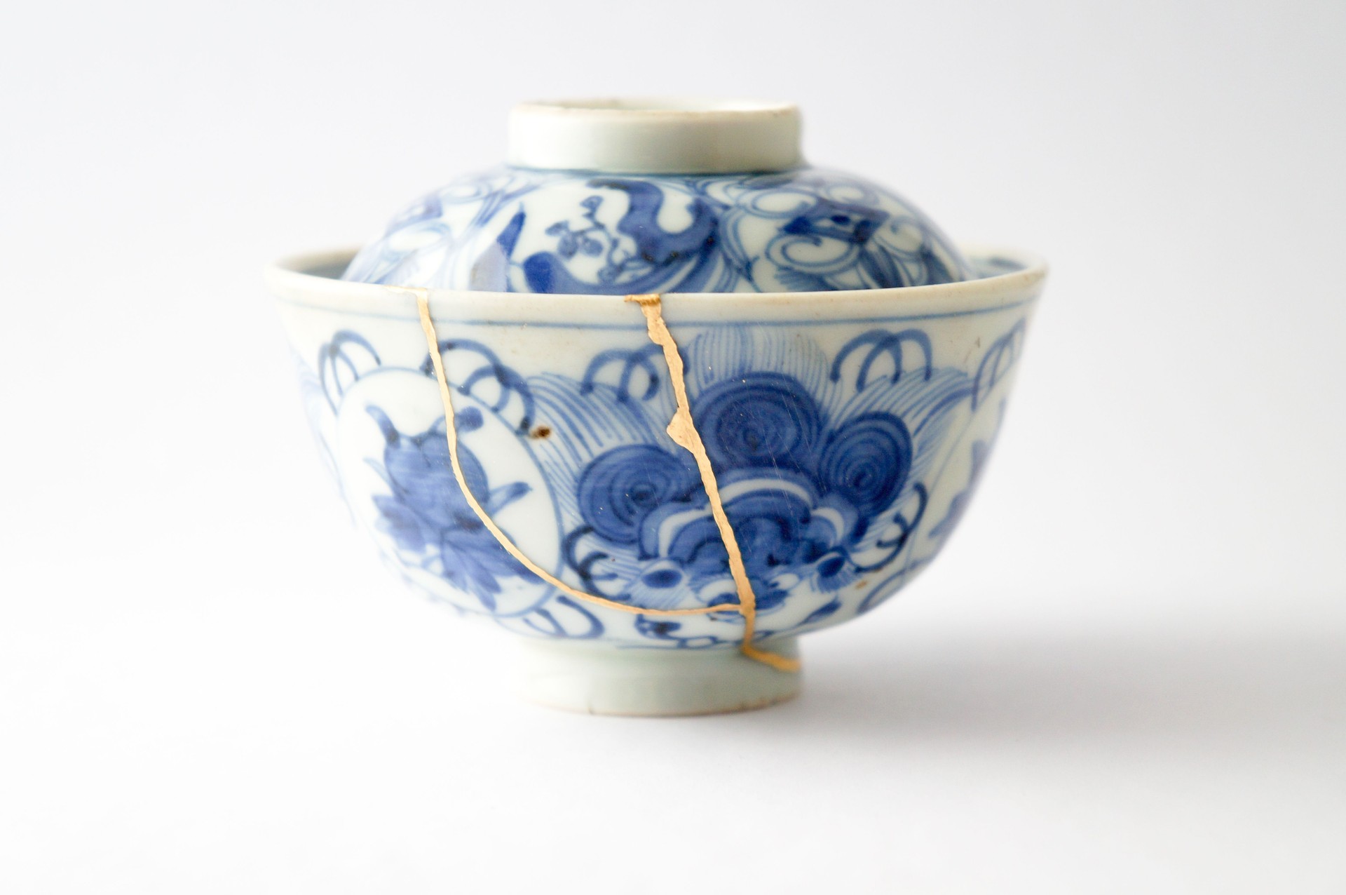 Antique broken Japanese blue bowl repaired with gold kintsugi technique